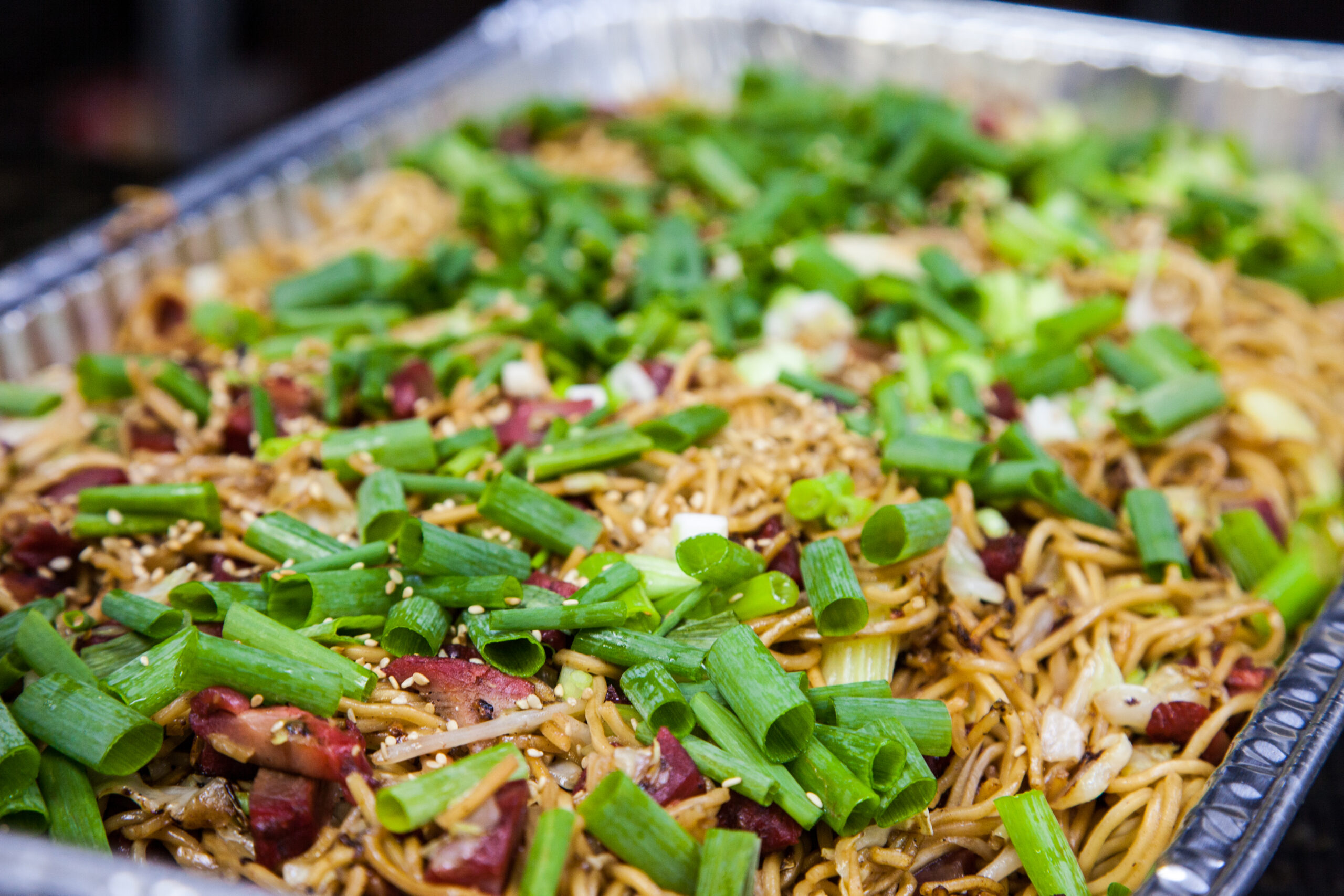 a catering tray of chow fun hawaiian plate lunch food